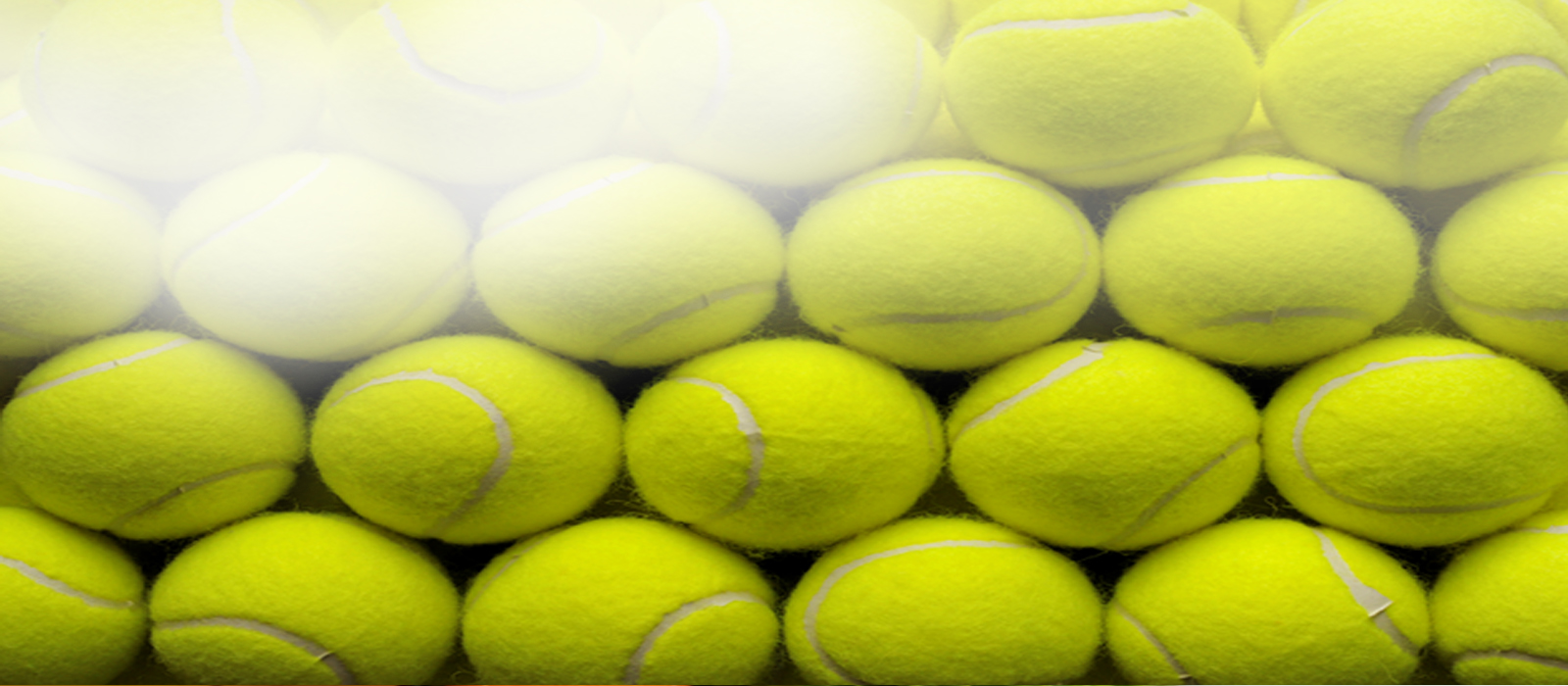 tennis balls stacked in rows