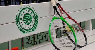tennis racquets on a bench at the indoor tennis court at The Club at Harper's Point