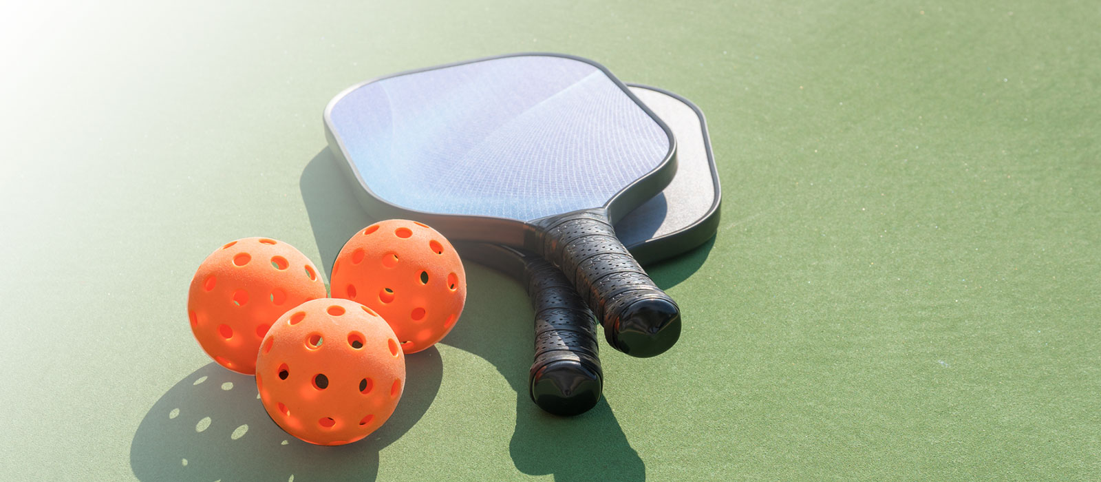 pickleball and racquets on court